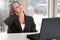 Businesswoman Sitting at Her Desk Tired