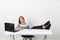 Businesswoman sitting at office feet on table