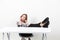 Businesswoman sitting at office feet on table