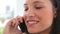 Businesswoman smiling as she talks on a phone