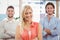 Businesswoman standing with arms crossed with male colleagues