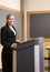 Businesswoman standing behind podium