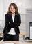 Businesswoman standing at desk in office