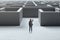 Businesswoman standing at entrance to a concrete labyrinth