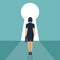 Businesswoman standing in front of a keyhole