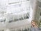 Businesswoman Standing In Office Atrium