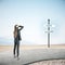 Businesswoman standing on road and looking on luck and failure sign post