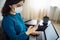 Businesswoman stays home and works during coronavirus epidemia quarantine. Female worker wearing a medical mask and holding her