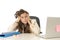 Businesswoman suffering stress at office computer desk looking worried depressed and overwhelmed