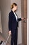 Businesswoman in suit holding room card