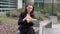 Businesswoman in suit snacking with sandwich on street