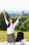 Businesswoman in sunny nature office hands up