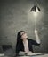Businesswoman switching on idea light bulb