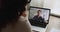 Businesswoman talk by videoconference, laptop screen view over female shoulder