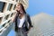 Businesswoman talking on phone on urban background