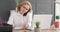 Businesswoman talking on phone and writing notes at office