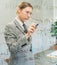 Businesswoman is thinking, writing on board with blue pen in meeting room