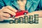 Businesswoman and toy car on coin stack - retro style