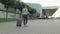 Businesswoman traveler walking with luggage to airport. Girl walks and rolls suitcase bag. Tourism