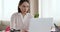 Businesswoman typing on laptop at office desk