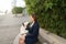 Businesswoman typing message and listening to music outside with