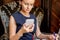 Businesswoman uses smartphone sitting in armchair