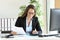 Businesswoman using a calculator at office