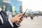 Businesswoman using her smart phone in working environment