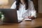 Businesswoman using laptop for online income tax return form. Symbolic of financial research, government taxes, and tax