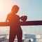 Businesswoman using tablet computer at the airport. silhouette of a girl traveler with backpack