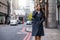 Businesswoman walking down the street in the City of London, UK