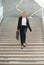 Businesswoman walking downstairs with briefcase