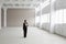 Businesswoman Walking In Empty Warehouse