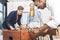 businesswoman watching multicultural colleagues playing table football