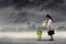 Businesswoman watering plant under air pollution