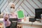 businesswoman wear head scarf and mask standing at her store showing blank tablet pc