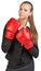 Businesswoman wearing boxing gloves, giving tough