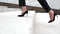 Businesswoman wearing heels climbing the Stairs in the city. Slow motion Close up on legs.