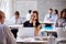 Businesswoman Wearing Smart Watch In Busy Office