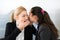 Businesswoman whispering to colleague