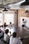 Businesswoman At Whiteboard Giving Presentation In Boardroom