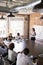 Businesswoman At Whiteboard Giving Presentation In Boardroom