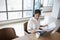 Businesswoman Working Alone On Laptop In Office Boardroom