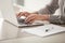 Businesswoman working on laptop, female hands typing on keyboard