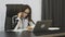 Businesswoman working in modern office. Confident female writing notes while talking on phone. Thoughtful concerned woman negotiat