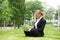 Businesswoman working outdoors on laptop