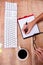 Businesswoman writing on diary on desk