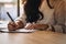 businesswoman writing on paper at workplace. young female entrepreneur woman handwriting note at office. paperwork on table.