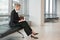 Businesswoman Writing In Planner At Office Lobby