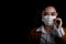 Businesswoman of young Asia woman putting on a respirator N95 mask to protect from airborne respiratory diseases as the flu covid-